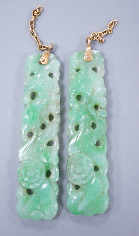 A pair of carved jade earrings, lacking mounts, 37mm.